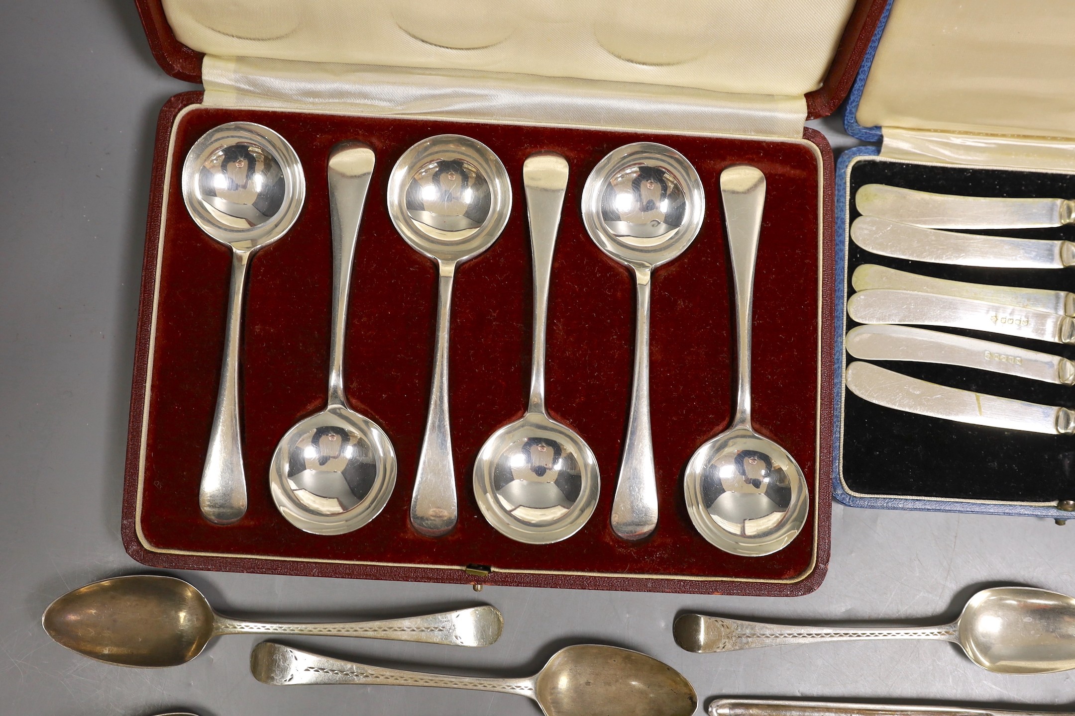 A cased set of George V silver Old English pattern soup spoons, Harrod's Ltd, Sheffield, 1934 and a cased set of six silver handled tea knives and sundry silver and white metal flatware.